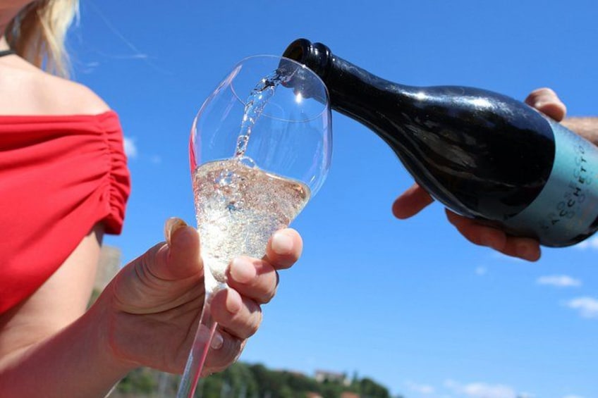 A person pouring champagne into a glass. 5