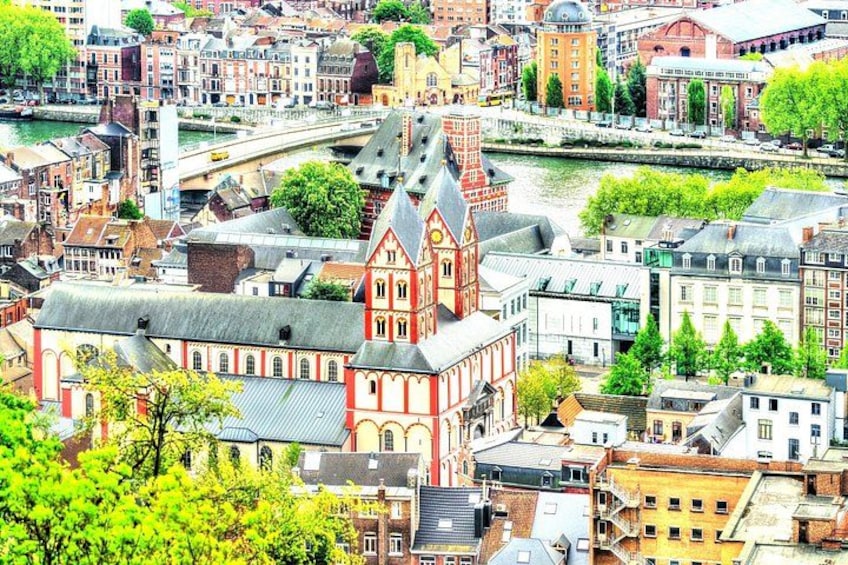 A cityscape with a prominent red church, a river, and surrounding buildings. 5