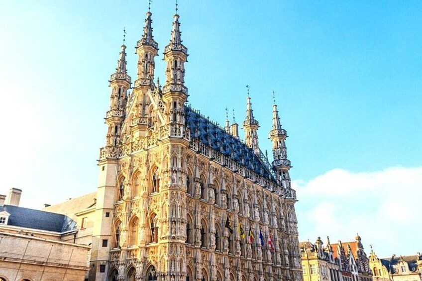 A historic cathedral with intricate architecture, multiple spires, and flags. 3