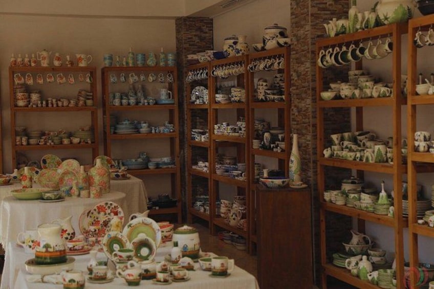 A pottery shop with shelves of ceramic items. 5