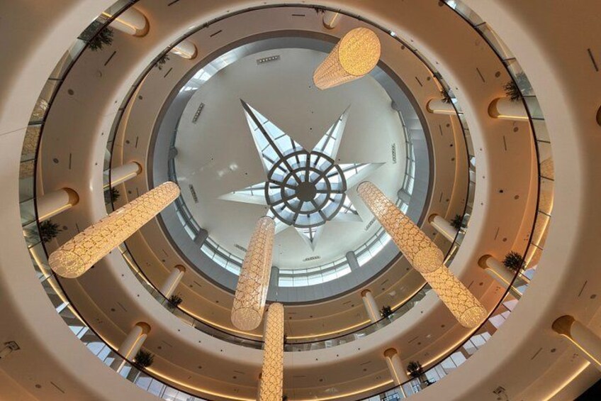 A circular architectural design with a central star-like structure and multiple levels. 5