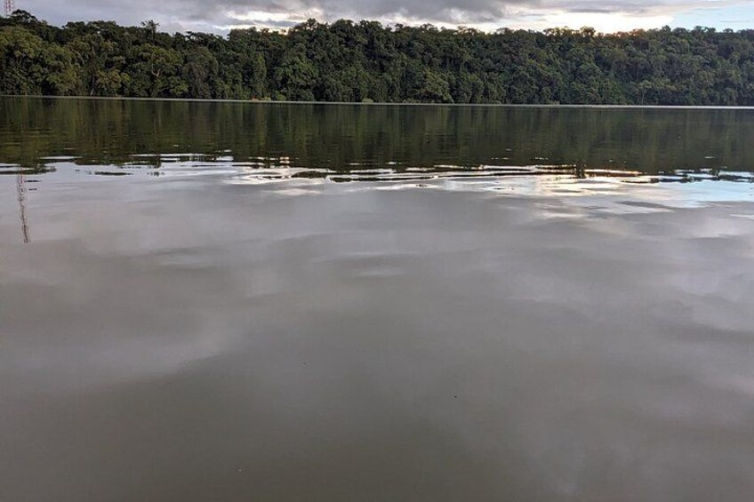 A calm lake with a forested shoreline. 5