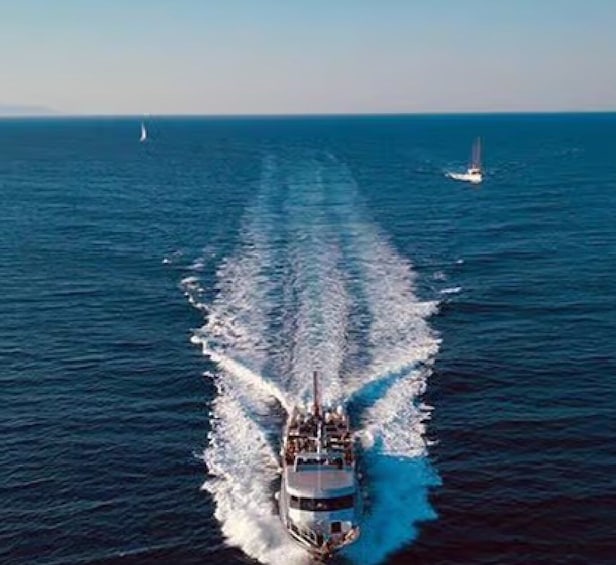 A large cruise ship moving through the ocean, leaving a wake behind it. 5