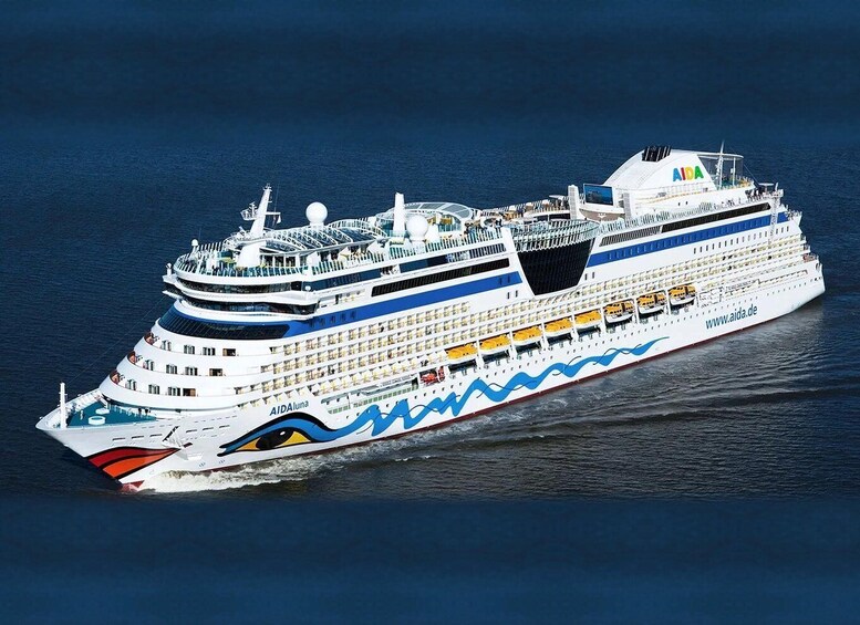 A large cruise ship with multiple decks and a distinctive blue and red design on its hull. 1