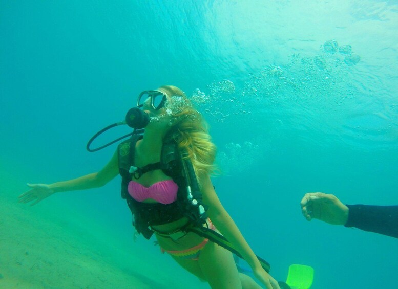 A person scuba diving underwater. 4