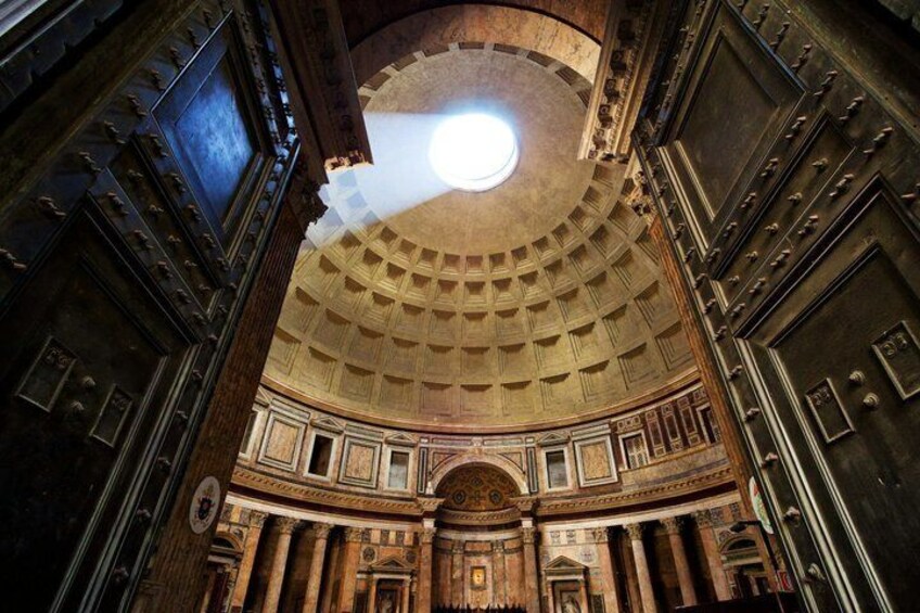 An ornate interior with a domed ceiling and classical architecture. 4