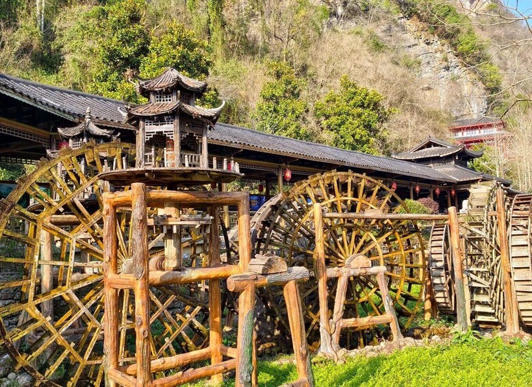 Traditional wooden water wheels and a pagoda-style building. 3