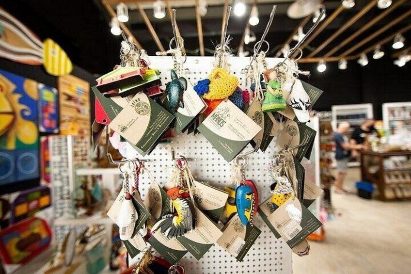 A display of keychains and tags hanging on a pegboard in a store. 4