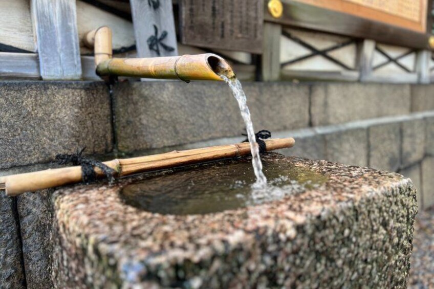 A traditional stone water feature with bamboo spouts. 4
