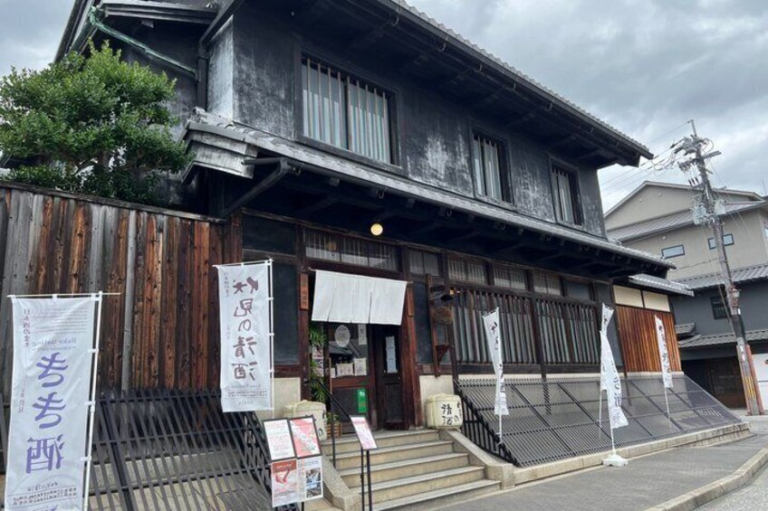 A traditional Japanese building with wooden exterior and signage. 5