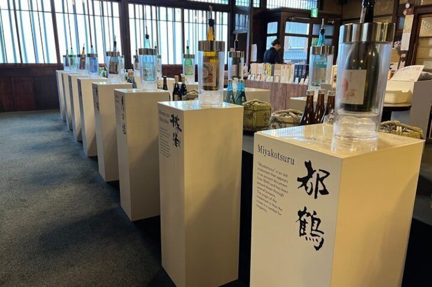 A series of display cases with bottles and informational placards in a museum or exhibition setting. 2