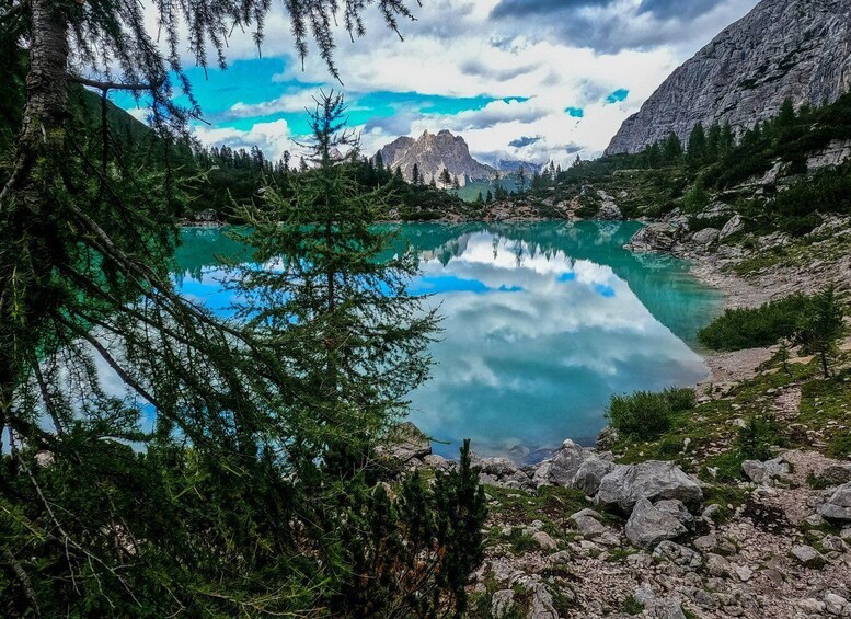 A mountain lake surrounded by trees and rocky terrain. 3