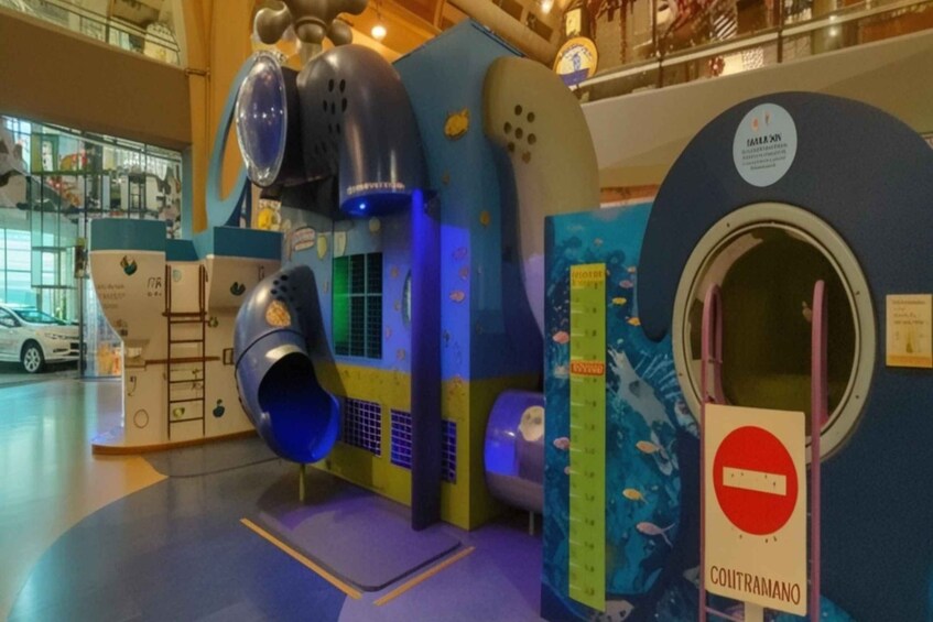 A children's play area with a slide, climbing structures, and a sign reading 'COUTRAMANO.' 5