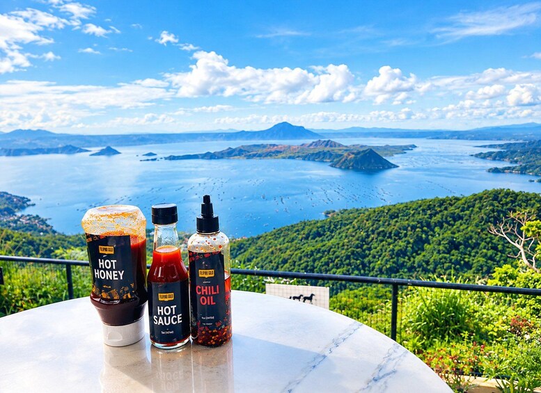 A table with condiments and a scenic view of a lake and mountains. 2