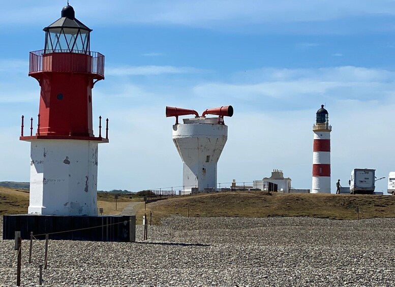 Three lighthouses on a rocky shore with clear skies. 3