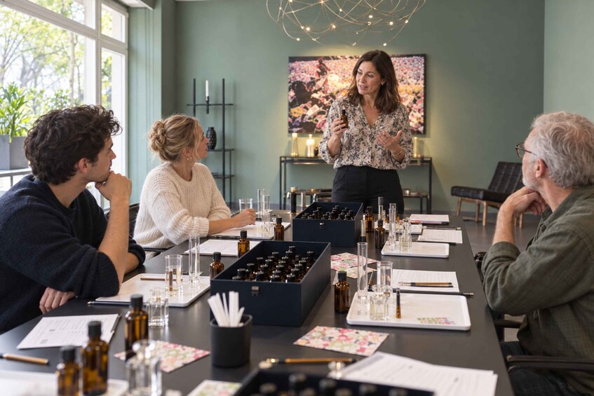 A meeting with people around a table with various bottles and papers. 2