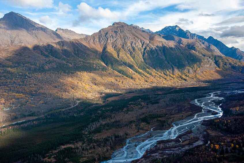 A river winding through a mountainous landscape with autumn foliage. 2