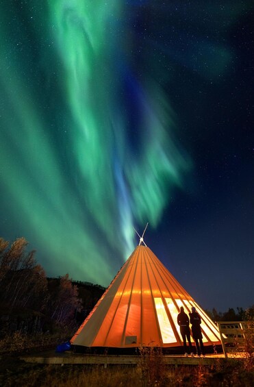 A tent under a night sky with the Northern Lights. 4