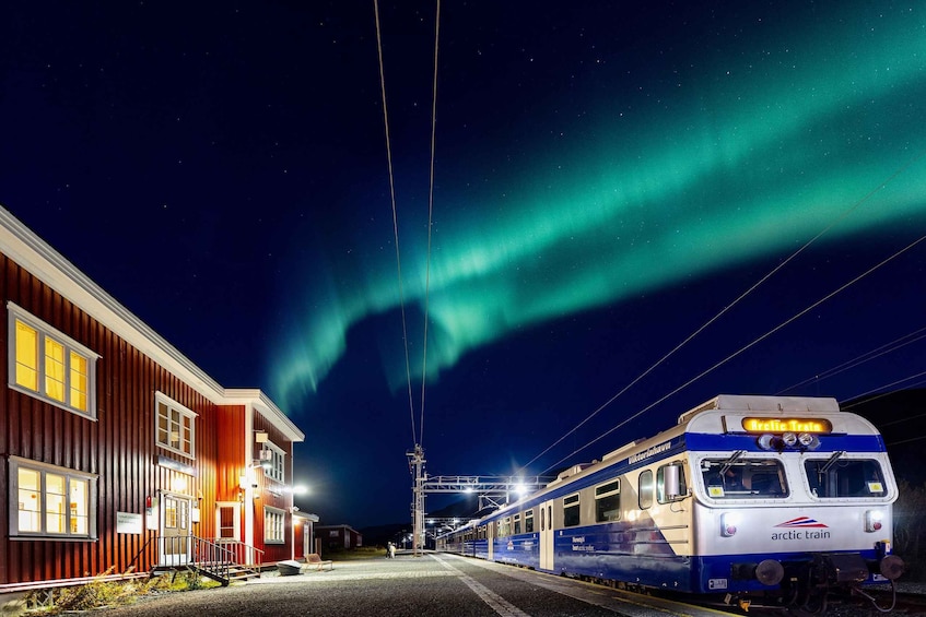 A train station at night with a Northern Lights display. 3