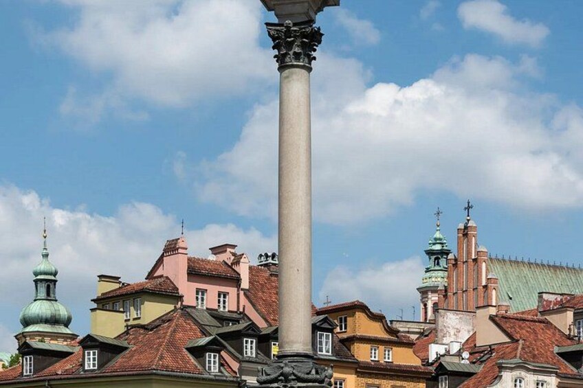 A historic building with a tall column, domed roof, and colorful facades. 3