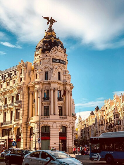 A historic building with ornate architecture and a statue on top, labeled 'METROPOLIS.' 2