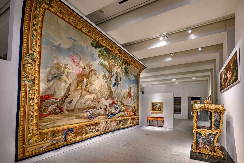 A grand hallway with a large mural, a golden ornate mirror, and classical paintings. 5