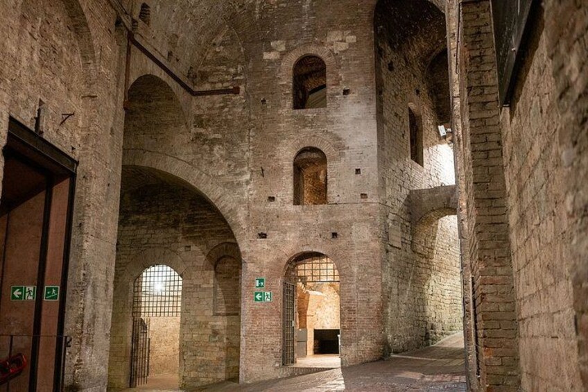 An interior of a historic stone building with arched doorways and windows. 2