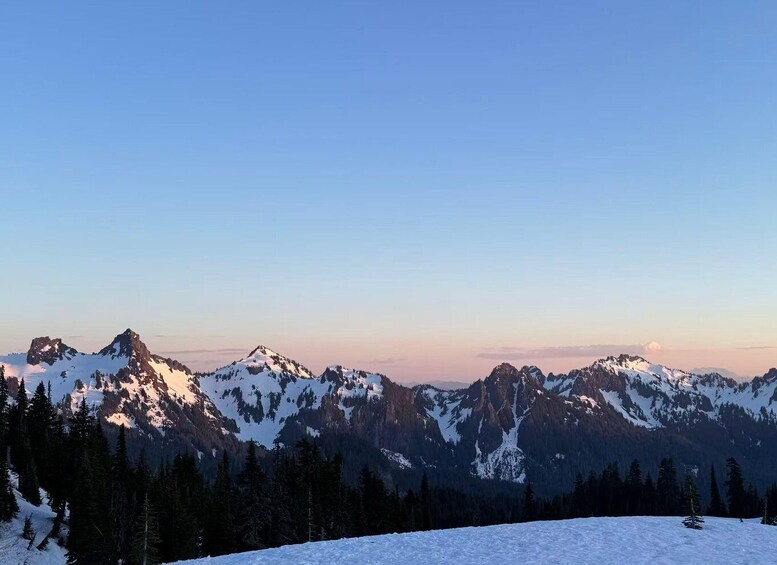 A snow-covered mountain range with clear skies. 4