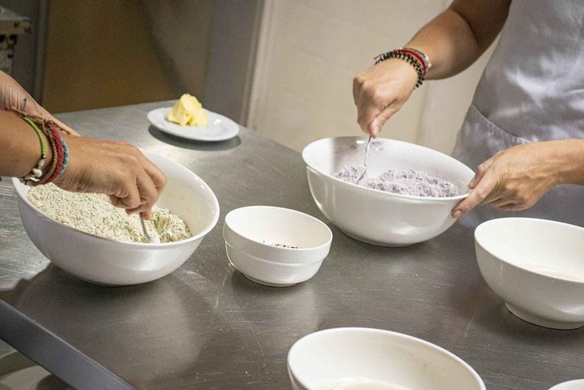 A person mixing ingredients in a kitchen. 5