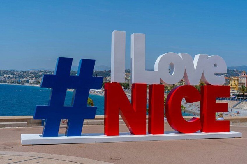 A large outdoor sign with the words 'I Love Nice' and a hashtag symbol. 4