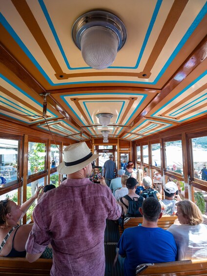 The interior of a boat with wooden paneling and blue trim. 5