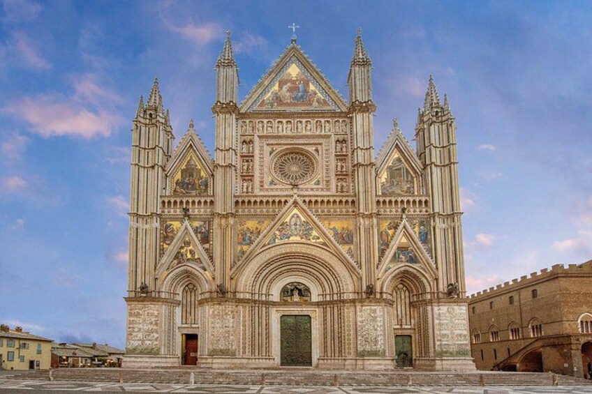 A large cathedral with intricate Gothic architecture, featuring multiple spires and detailed stone carvings. 1