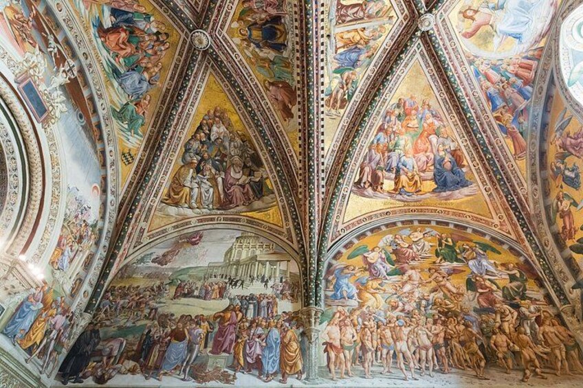 A detailed ceiling fresco with religious scenes and architectural elements. 2