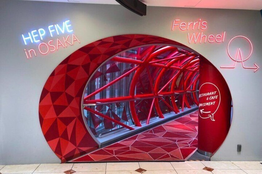 A Ferris wheel with a geometric design and the text 'HEP FIVE in OSAKA' and 'Ferris Wheel' on the wall. 3