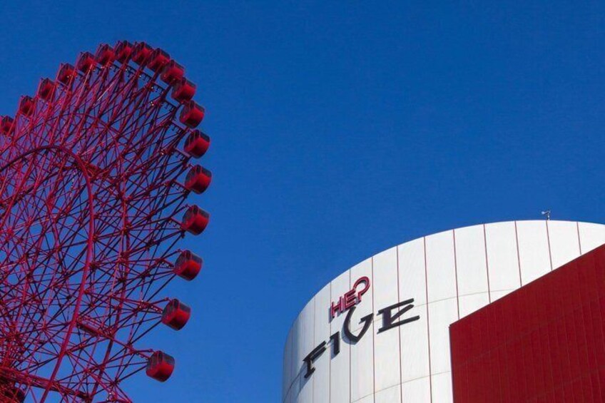 A Ferris wheel and a building with 'FIVE' written on it. 1