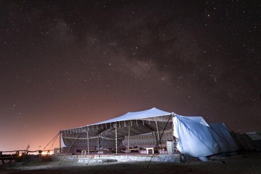A large, white tent under a starry night sky. 3