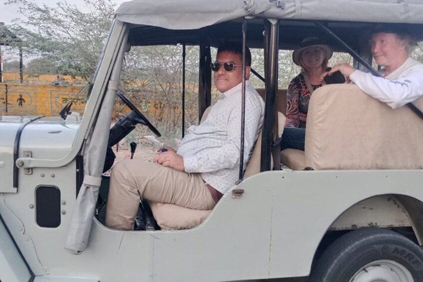 A safari vehicle with passengers. 5
