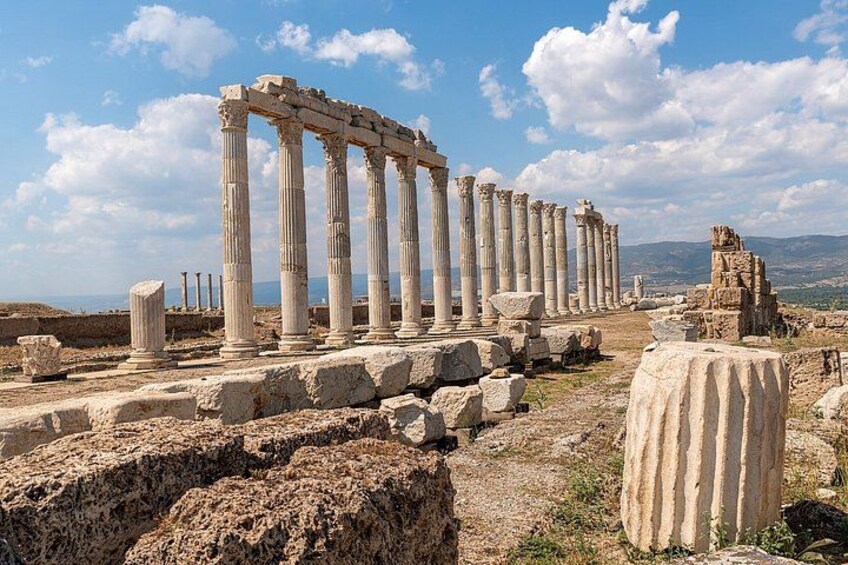 Ancient ruins with columns and stone structures. 4