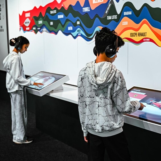 Two people using interactive displays in a museum. 3