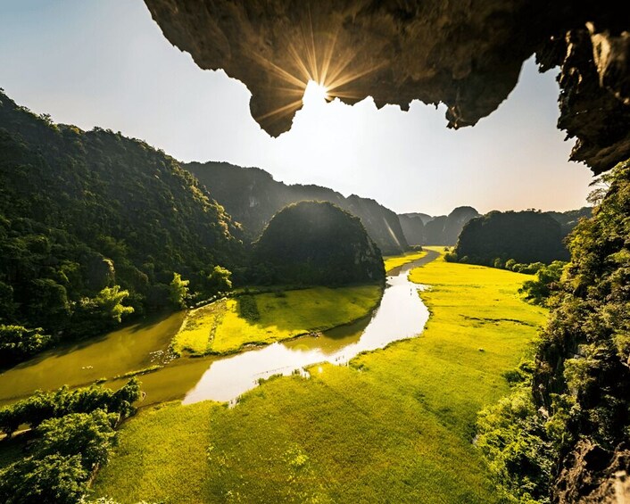 A river winding through a valley with lush greenery and rocky cliffs. 4