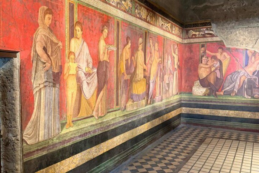 A fresco mural with figures in classical attire, a checkered floor, and architectural details. 5