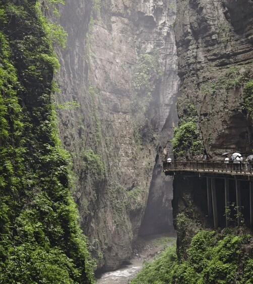 A narrow gorge with a bridge and a river. 2
