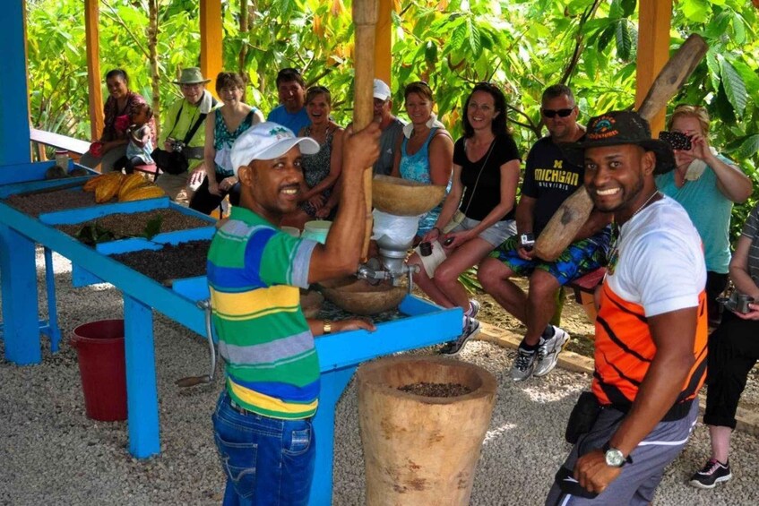 People milling coffee beans at a traditional coffee mill. 3