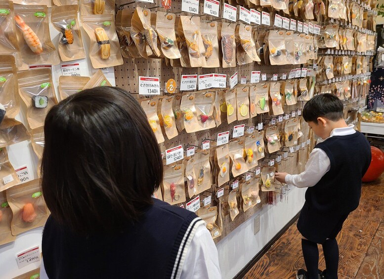 A person browsing a wall of packaged goods in a store. 2