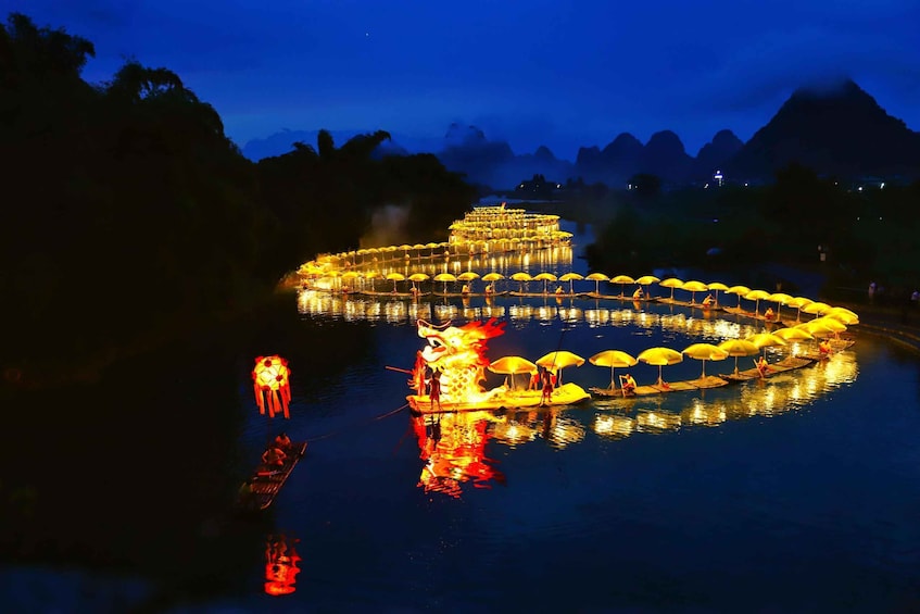 A nighttime river scene with illuminated boats and a dragon float. 2