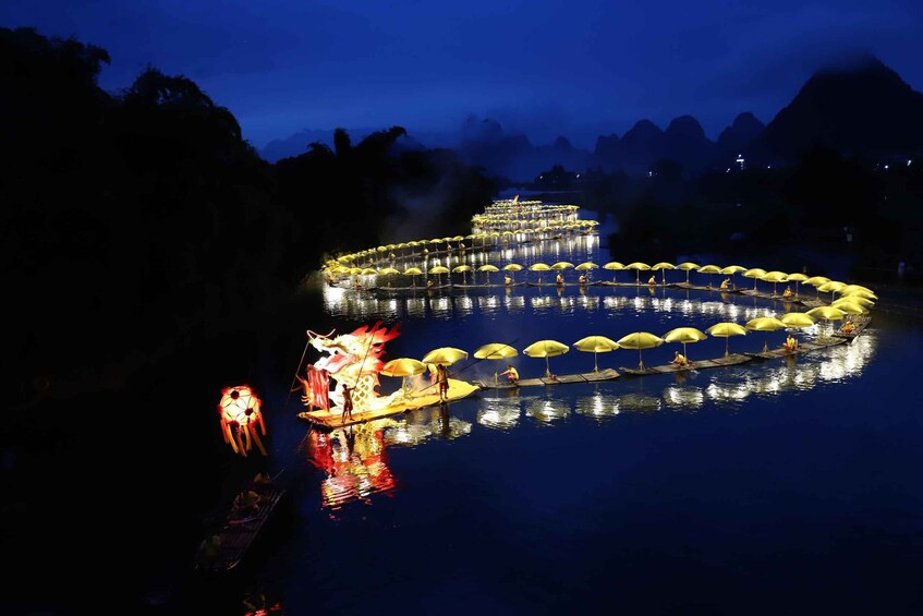 A nighttime water festival with illuminated boats and a dragon float. 4
