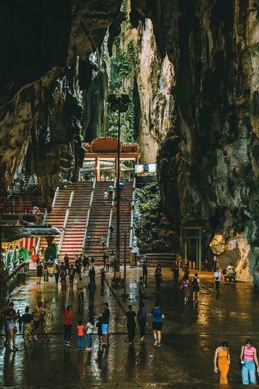 A cave with stairs leading to a covered area, surrounded by rock formations. 5