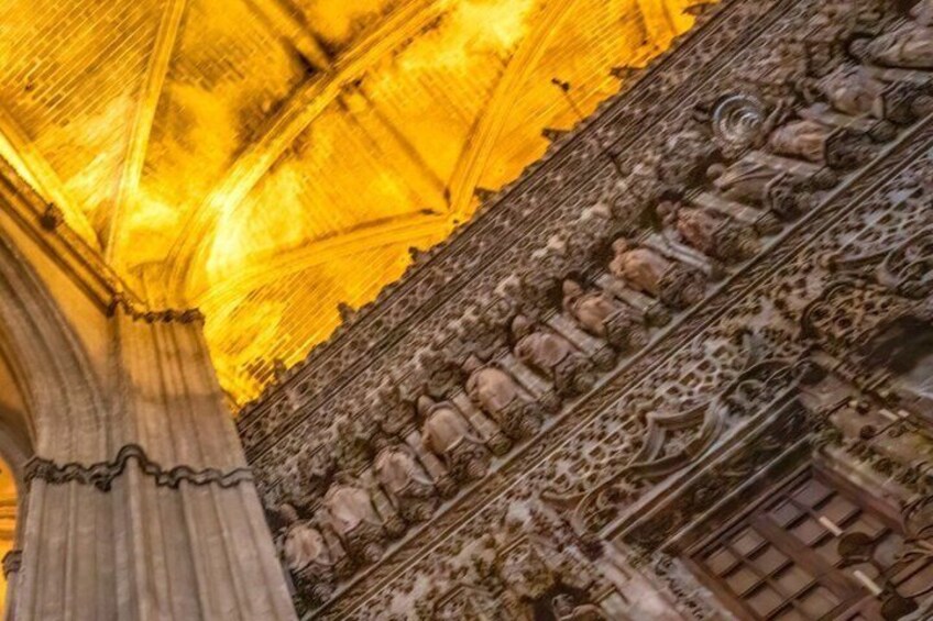 A cathedral interior with detailed stone carvings and a golden stained glass ceiling. 3