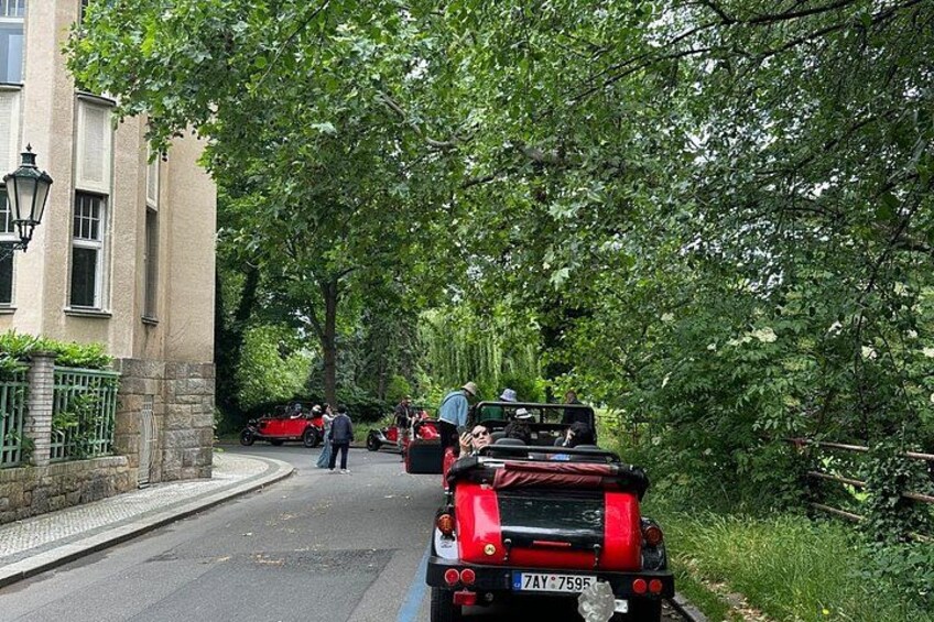 A road lined with trees and parked cars. 3