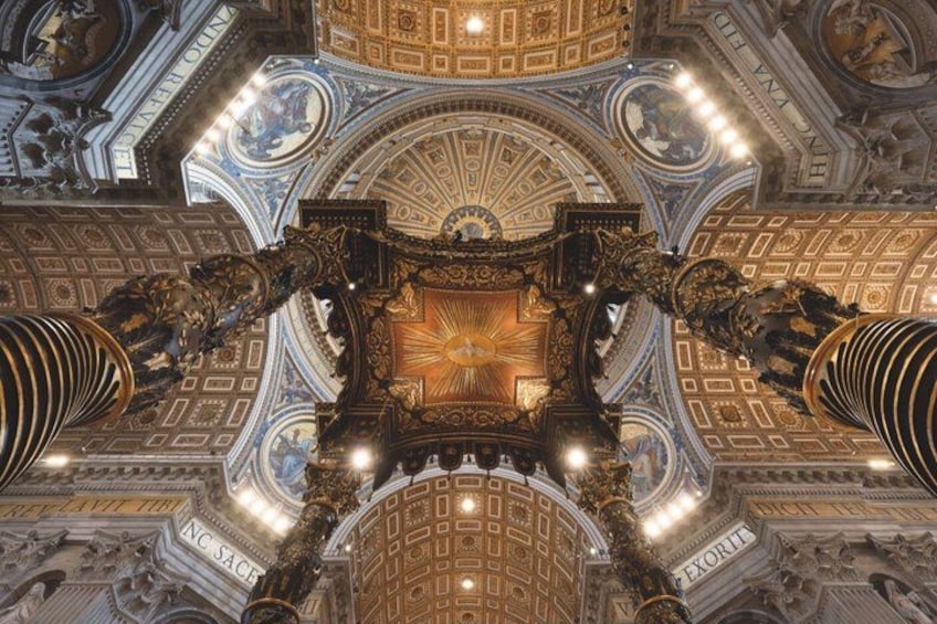 A grand architectural ceiling with intricate designs and inscriptions. 3